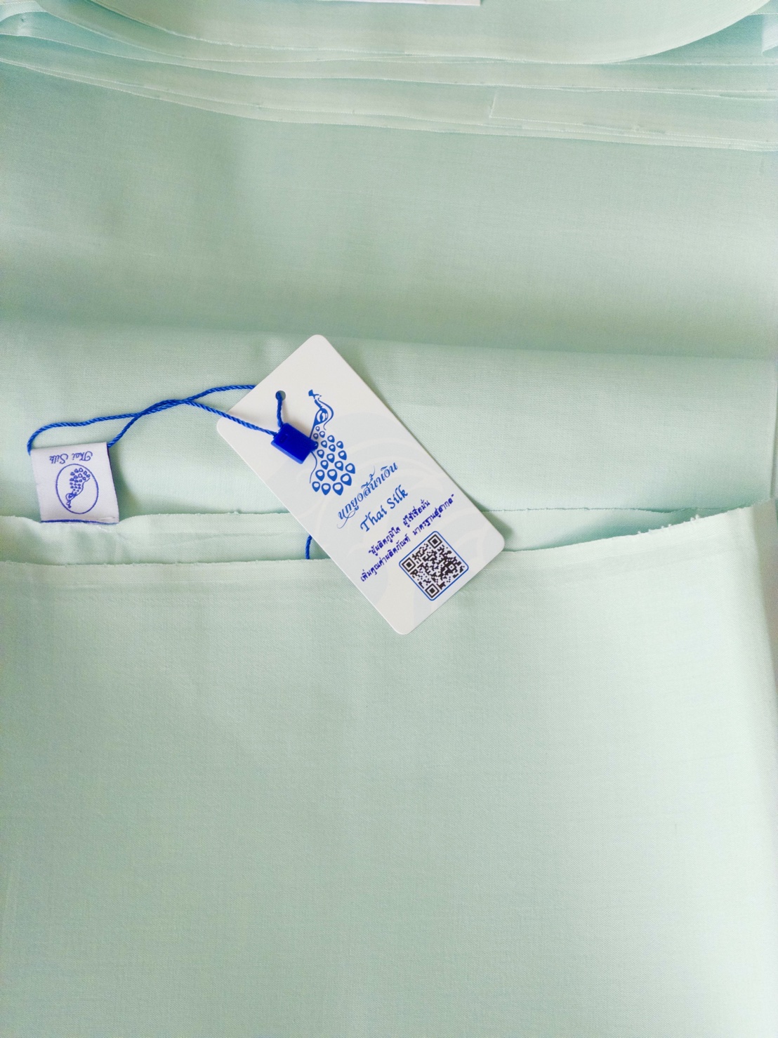 ผ้าไหมสีพื้น เนื้อเรียบ ตรานกยูงพระราชทาน สีเขียวมิ้นต์อมฟ้าอ่อน (ราคาต่อหลา) รหัส C-119-2025PC1