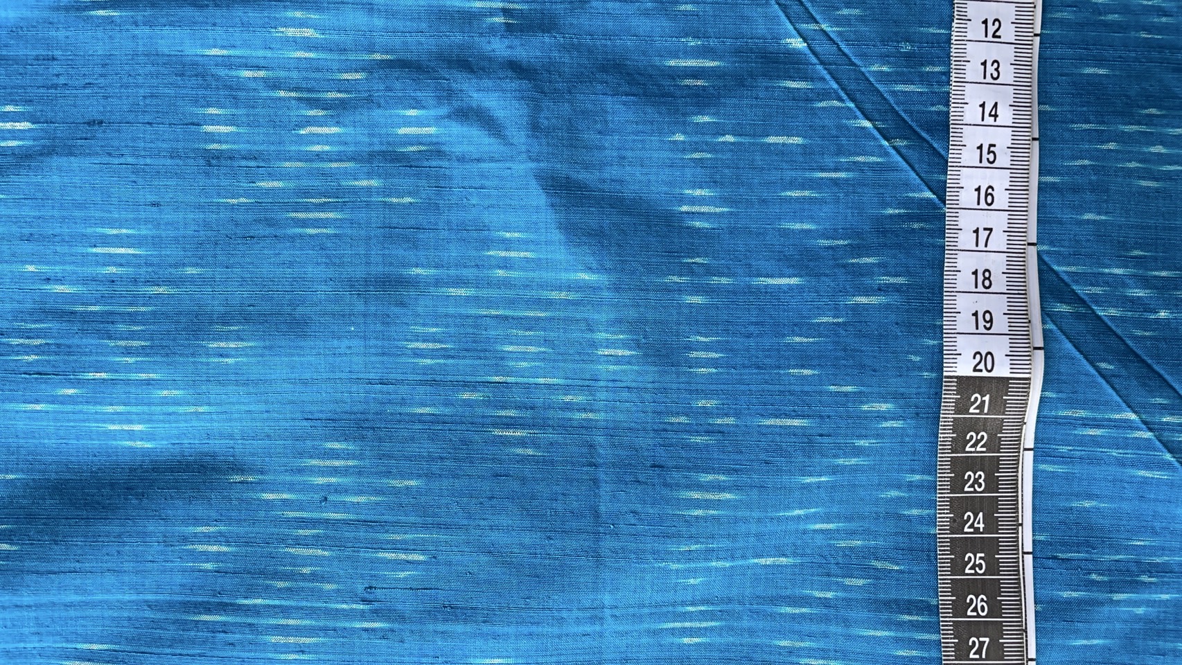 ผ้าไหมมัดหมี่ เนื้อไหมบ้าน ไหมแท้ ลายดอกแก้ว สีฟ้า ตัดขายเป็นเมตร รหัส CISP-NY-SKU-44173