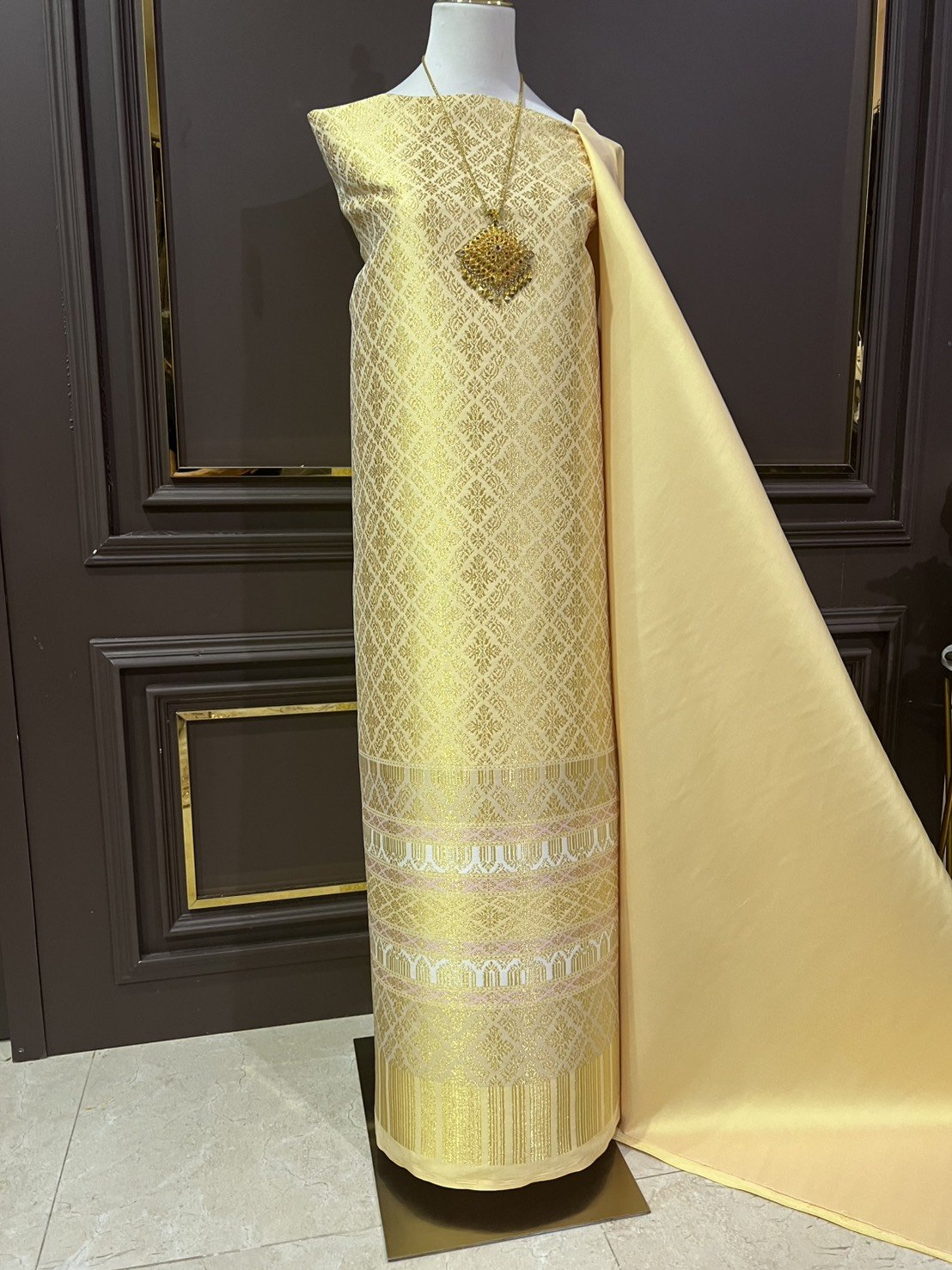 (ผ้าชุด)ผ้าไหมยกดอกลำพูน เกาะเชิงดิ้นทอง ขนาด 1.02x4.53เมตร ลายอมรพรรณ พื้นสีเหลืองเทา รหัส N90-29-TR0551